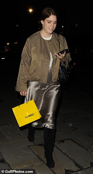 Holding a little Selfridges bag in her one hand, the other hand held her phone, which she was pictured using as she left the lavish London restaurant