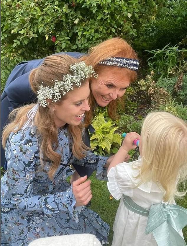 Sarah and Beatrice smiling at the princesses' daughter, Sienna