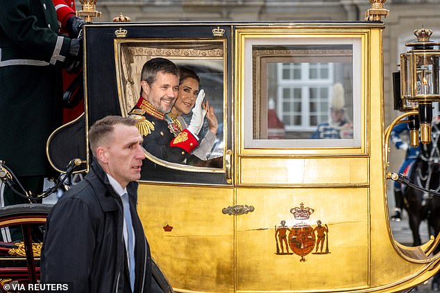 The royal couple waved at onlookers as they travelled by carriage from Amalienborg Palace to the New Year's reception at Christiansborg Palace