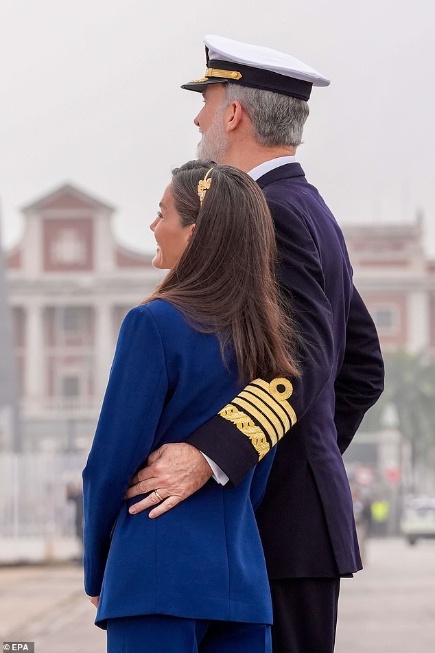 At one point, Felipe sweetly wrapped his arm around Letizia's waist, while surrounded by cheering locals, as they watched Leonor embark on a new chapter.