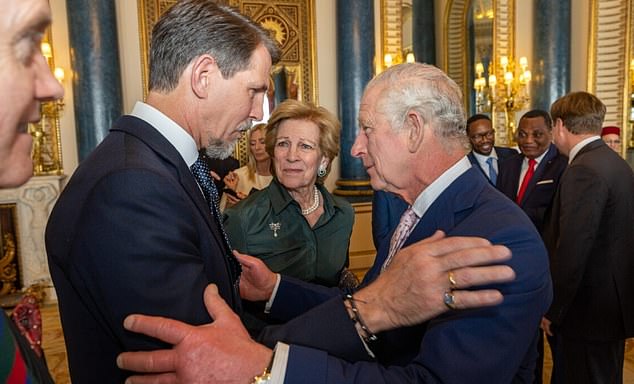 King Charles III greets Pavlos of Greece at an event during his coronation in 2023