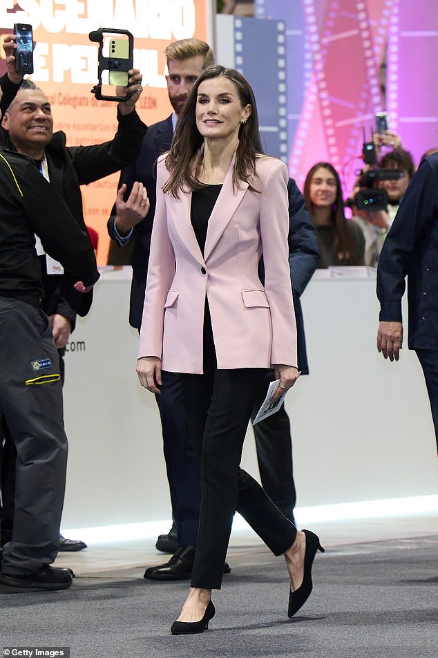 The monarch completed her outfit with modest black kitten-heels as she is believed to have been suffering from Morton's neuroma in her left foot since 2022