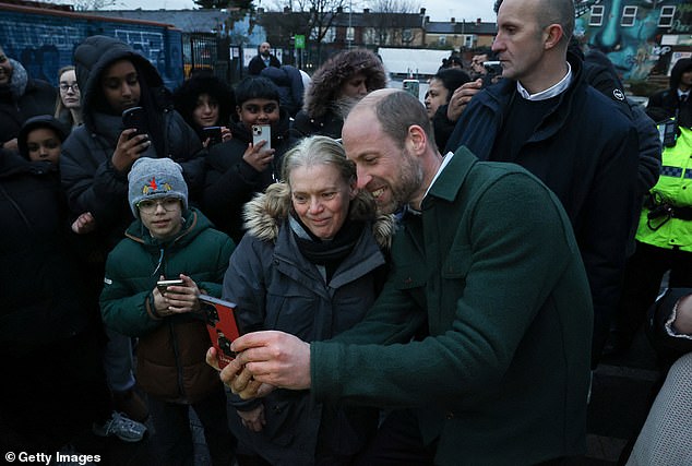 The prince also took the time to take selfies with members of the community who had braved the cold to meet him