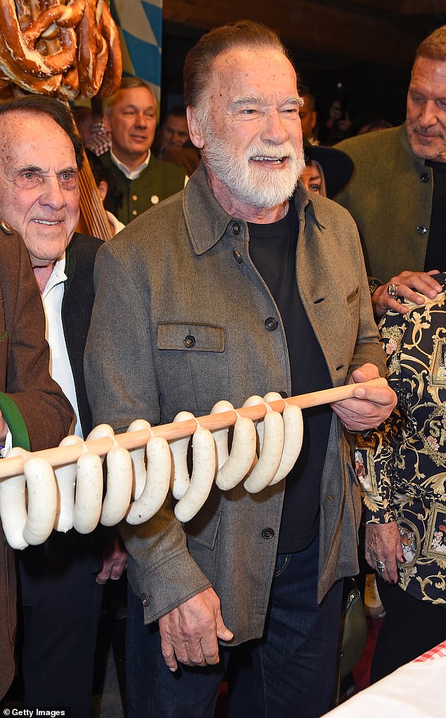 The Hollywood actor proudly held up a string of traditional white sausages at a ski resort's Weißwurstparty