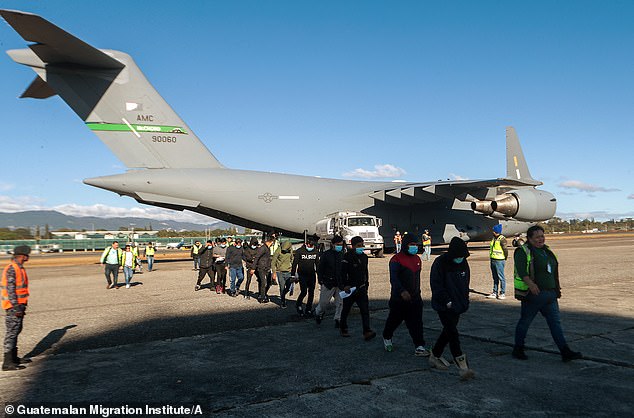 Trump is working with El Salvador to try and reach a deal on them accepting deportation flights of migrants from third-party nations. Pictured: Migrants deplane a U.S. military aircraft after it landed in Guatemala on January 24, 2025