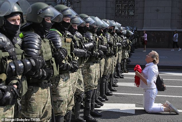 A Belarusian opposition supporter kneels in front of riot police in 2020. In response to months of protests, Lukashenko arrested 65,000 people and forced opposition figures to flee abroad