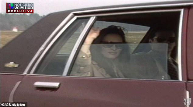 While in the car, Melania touched up her makeup, and then waved to the 'crowd' outside