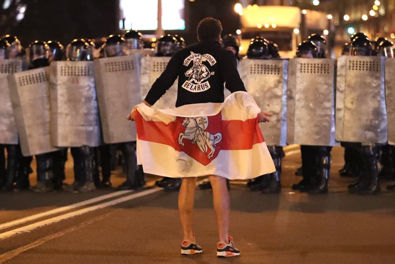 A demonstrator stands in front of riot police during a protest after polling stations closed in the presidential elections, in Minsk, Belarus, in August 2020. On Monday, Britain and Canada imposed sanctions targeting Belarus' dictator president of Alexander Lukashenko following another contested presidential election over the weekend. File photo by Tatyana Zenkovich/AEPA-EFE