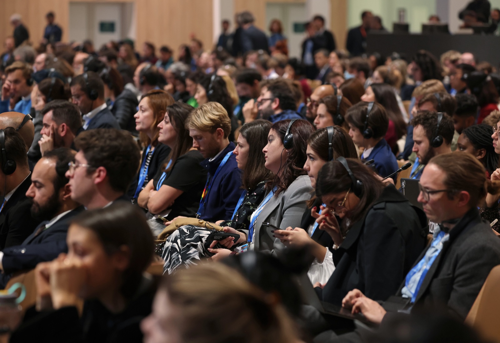 A room full of seated participants wearing business clothing