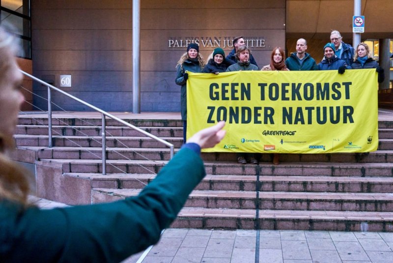 Members of Greenpeace protest in front of the court in The Hague, the Netherlands, on Wednesday. A judge ruled for Greenpeace Netherlands' merits against the state. Greenpeace demands that nitrogen emissions be drastically reduced to protect nitrogen-sensitive nature. Photo By Phil Nijhuis/EPA-EFE