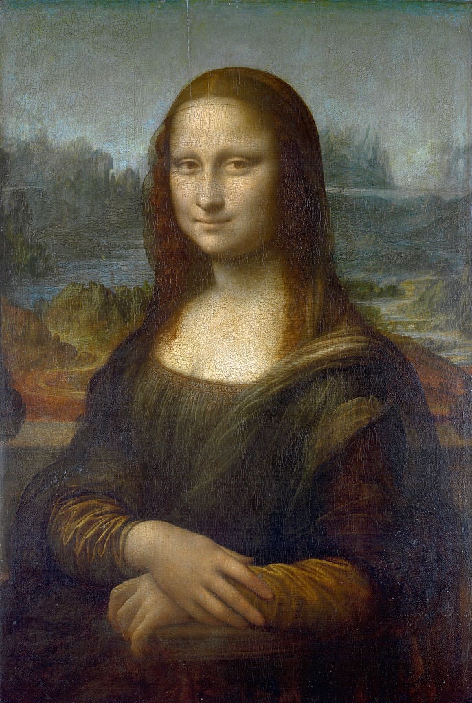 Leonardo's Mona Lisa portrait of a woman, slightly smiling, depicted in front of a landscape of rocks and a body of water