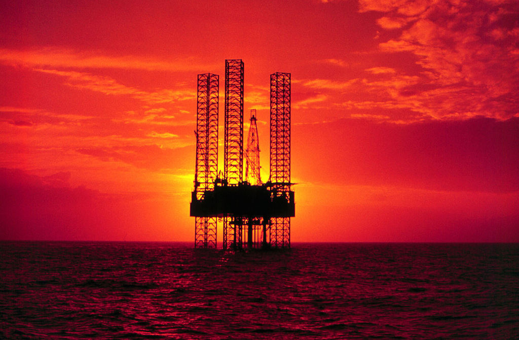 A Devon-Pennzenergy drilling rig In the Gulf of Mexico pictured at sunset.