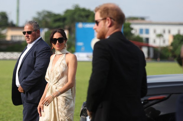 Britain's Meghan (C), Duchess of Sussex, and Britain's Prince Harry (R), Duke of Sussex, arrive at a charity polo game at the Ikoyi Polo Club in Lagos on May 12, 2024 as they visit Nigeria as part of celebrations of Invictus Games anniversary. (Photo by Kola Sulaimon / AFP) (Photo by KOLA SULAIMON/AFP via Getty Images)