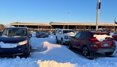 Snow and ice cover cars at KCI Economy Parking lot
