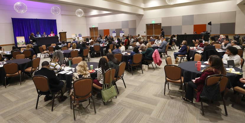 A large group of attendees listen in on a panel discussion during a morning session at the...