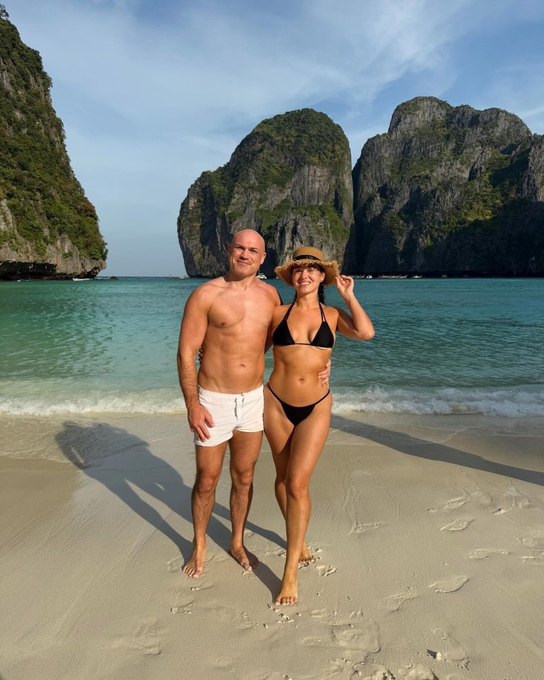 Couple in swimwear on a tropical beach.