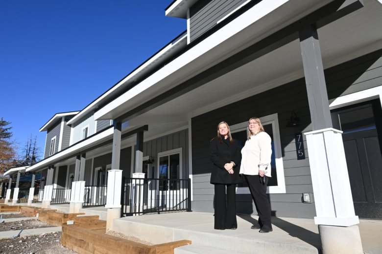 Two women sand infront of a multifamily housing complex in Craig, Colorado