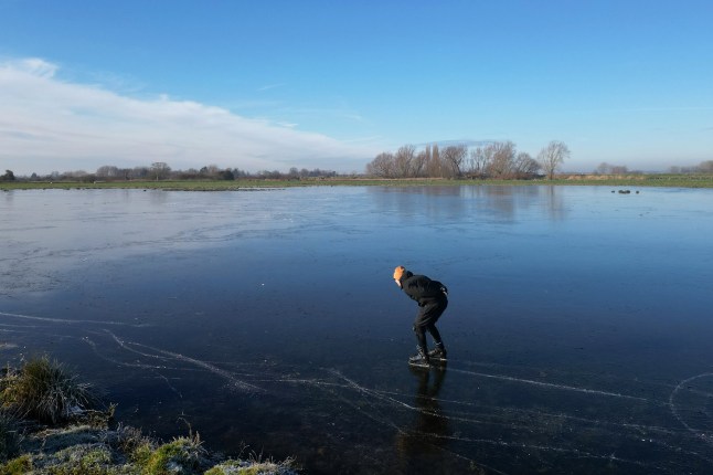 Ugo Sassi from Cambridge skates on a frozen flooded field in Upware, Cambridgeshire. The Cambridgeshire Fens were the birthplace of British speed skating and require four nights of frost, with a temperature of -4 or colder and little or no thawing during the days in between, to make ice strong enough to skate on. Temperatures will continue to fall over the coming days, with the mercury potentially reaching minus 20C in northern parts of the UK on Friday night. Weather warnings for ice are in place across the majority of Wales and Northern Ireland, as well as large parts of the east of England. Picture date: Friday January 10, 2025. PA Photo. See PA story WEATHER Winter. Photo credit should read: Joe Giddens/PA Wire