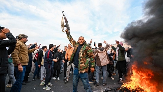 People celebrated at Umayyad Square in Damascus on December 8, 2024. Islamist-led rebels declared that they have taken Damascus in a lightning offensive on December 8, sending President Bashar al-Assad fleeing and ending five decades of Baath rule in Syria.(AFP)