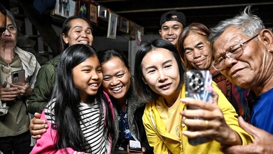 Thai farm worker Watchara Sriaoun, who was a hostage in Gaza, spoke via video call to his family and friends after his release by Hamas. The families of Thai farm workers held for over a year in Gaza cheered and wept with relief on January 30 after they freed.(Lillian Suwanrumpha/AFP)