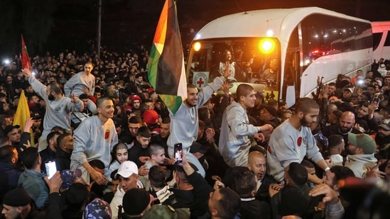 A huge crowd waving Palestinian flags was gathered waiting for the former detainees to arrive in a Red Cross convoy to Ramallah.(Ahmad Garhabali/AFP)