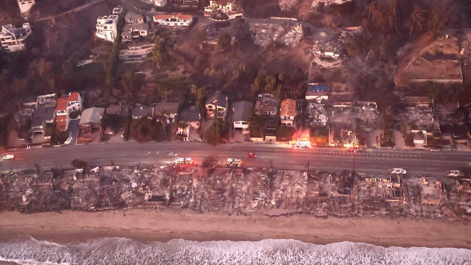 Los Angeles Wildfires: In an aerial view, destroyed homes are seen along the beach as the Palisades Fire continues to burn on January 09, 2025 in Malibu, California. Multiple wildfires fueled by intense Santa Ana Winds are burning across Los Angeles County.
