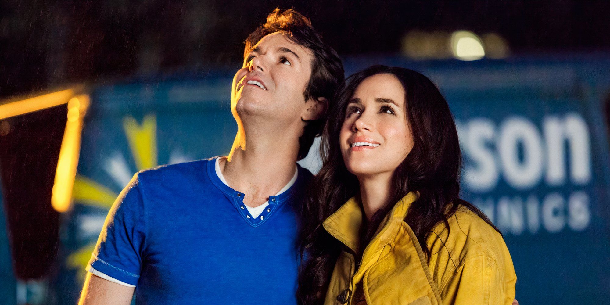 A man and woman looking up at the sky in the Hallmark movie When Sparks Fly