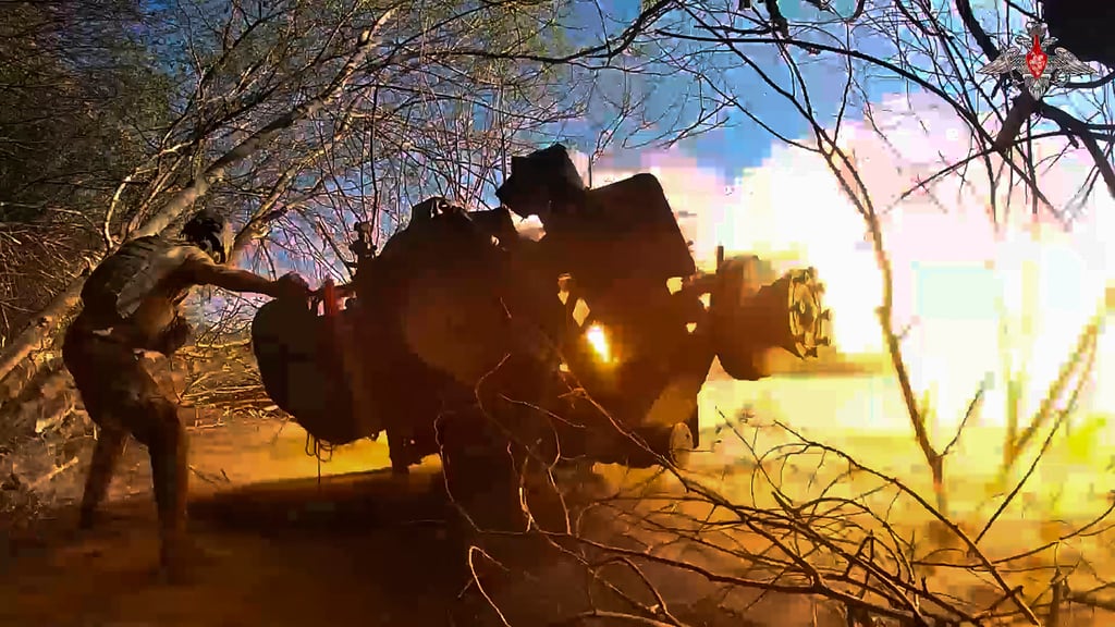 A Russian soldier fires a gun towards a Ukrainian position in the Kursk region last year, in this still from a video. Photo: Russian Defence Ministry Press Service via AP