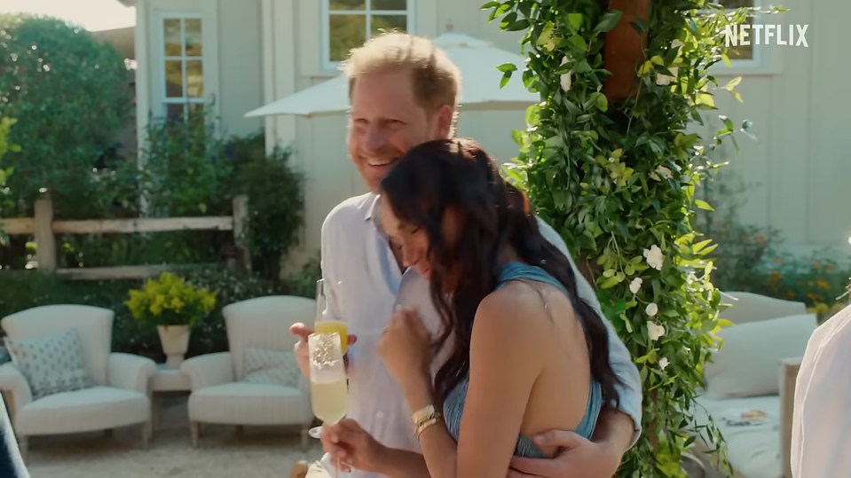 Prince Harry and Meghan Markle embracing outdoors.