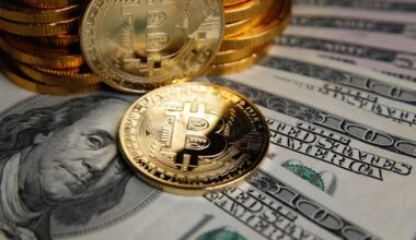 Bitcoin coins cryptocurrency on U.S. dollar banknotes background.