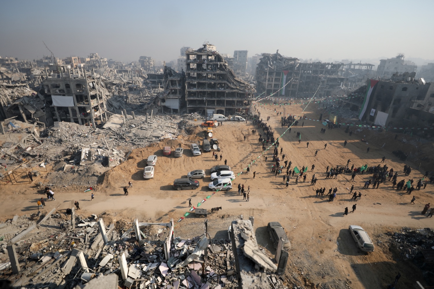 People gather at the site where eight more hostages — three Israelis and five Thais — are due to be handed over by Hamas fighters to the International Red Cross, in Jabalia in northern Gaza, on the morning of Jan 30. (Photo: Reuters)