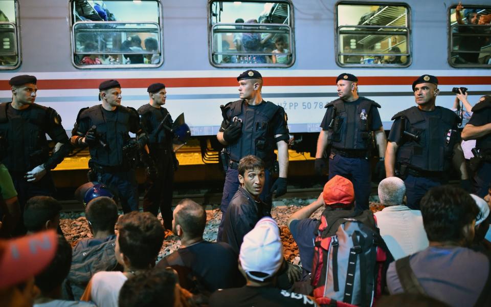 Migrants in Croatia board a train as they journey north