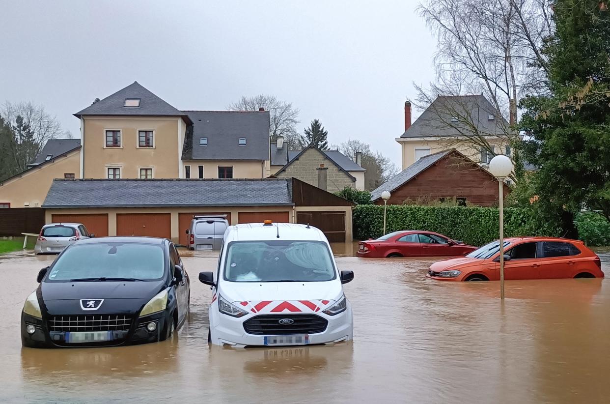 Cars submerged in water along a flooded street after the river Flume burst its banks in Pace, western France (AFP via Getty Images)
