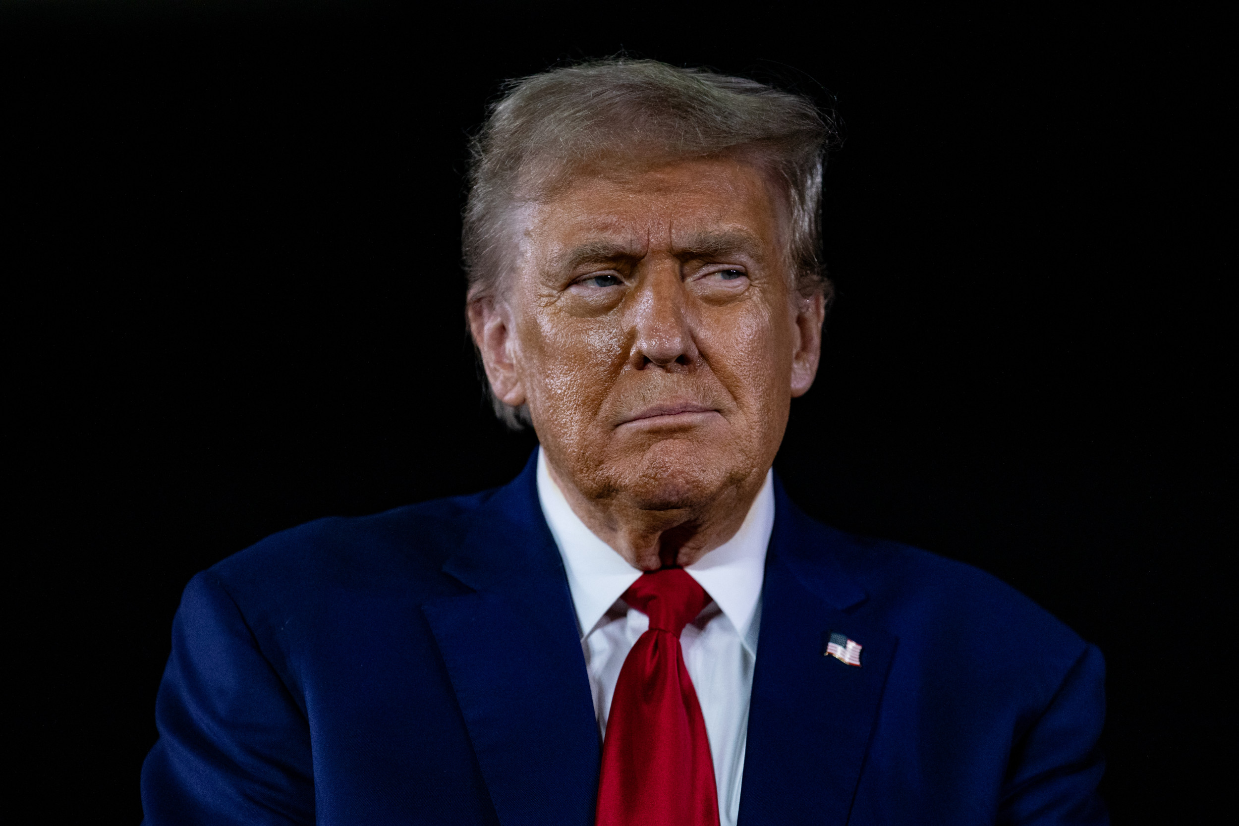 Donald Trump listens to questions