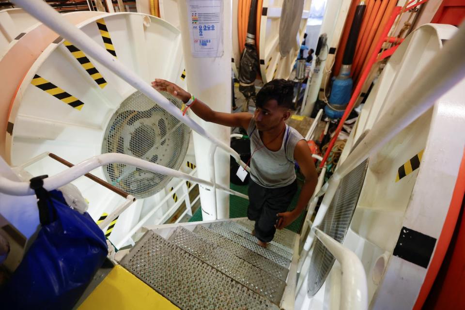 A migrant walks to disembark from the Geo Barents rescue ship, operated by Medecins Sans Frontieres (Doctors Without Borders), in Civitavecchia port, Italy October 1, 2023. 