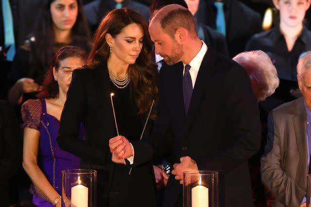 Dan Kitwood/Getty Catherine, Princess of Wales and Prince William, Prince of Wales light candles during a ceremony commemorating Holocaust Memorial Day on Jan. 27, 2025 in London, England
