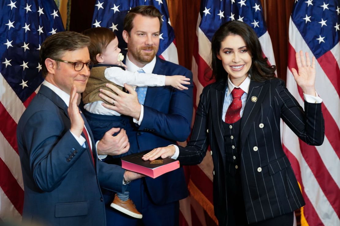 House Speaker Mike Johnson, left, poses during a ceremonial swearing-in with Rep. Anna Paulina Luna, R-Fla., right, and her family on the opening day of 119th Congress at the US Capitol on January 3, 2025 in Washington, DC.