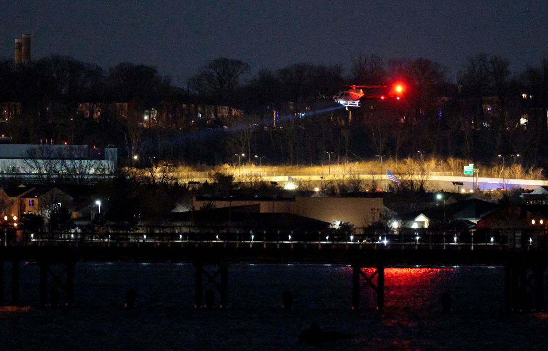A helicopter assists with search and rescue operations over the Potomac River near Ronald Reagan Washington Airport on Wednesday in Arlington, Virginia.