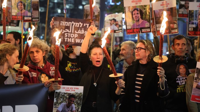 Family members of hostages held by Hamas in Gaza, along with their supporters, light torches as they react to ceasefire reports during a protest calling for the release of the hostages, in Tel Aviv, Israel, on January 15 2025