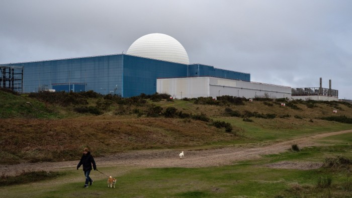 A man walks his dog past Sizewell B nuclear power station