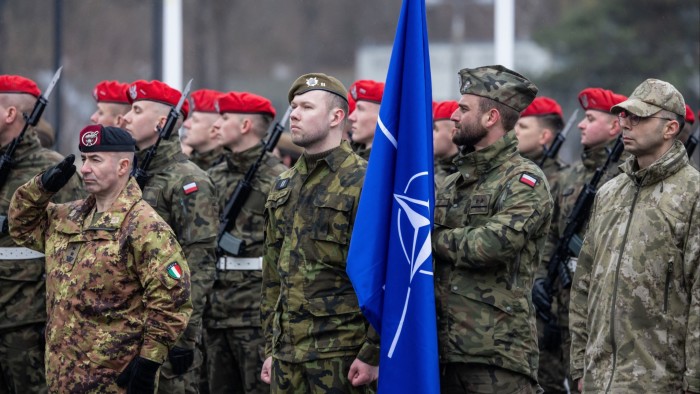 A Polish soldier holds a Nato flag at a ceremony commemorating the 25th anniversary of Poland joining Nato, on March 12 2024 in Warsaw.