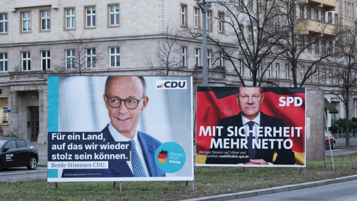 Campaign posters in Berlin promote the Christian Democrats’ Friedrich Merz, left, and the Social Democrat Olaf Scholz