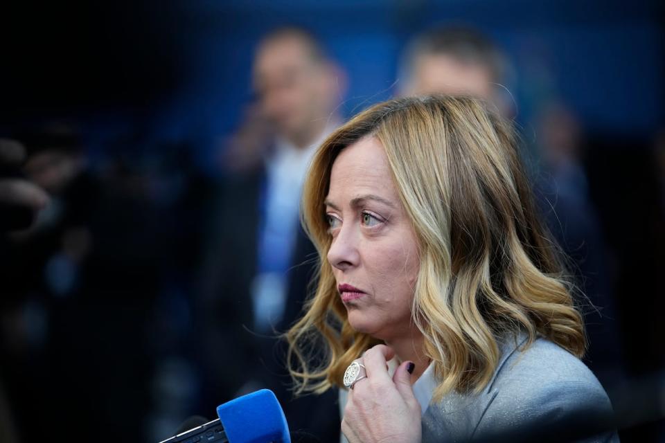 Italy's Prime Minister Giorgia Meloni speaks with the media as she arrives for an EU Summit at the Puskas Arena in Budapest, Hungary, Friday, Nov. 8, 2024.