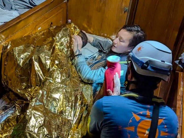 In this image made available on Thursday, Dec. 12, 2024, by CompassCollective, rescuers attend to an 11-year-old girl from Sierra Leone who was found floating in the Mediterranean Sea off Italy's southernmost Lampedusa island, and is believed to be the only survivor of a shipwrecked migrant boat that had departed from the port of Sfax in Tunisia.