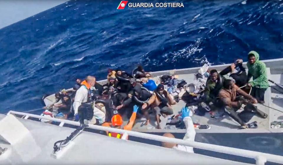 In this image taken from a video released by the Italian Coast Guard on Thursday, April 11, 2024, a boat with migrants is approached by a rescue operation off the island of Lampedusa in the Mediterranean Sea. The Italian Coast Guard rescued 22 people and recovered nine bodies on Thursday, April 10, 2024, after a smugglers' boat capsized in storm about 30 miles south of the island of Lampedusa.