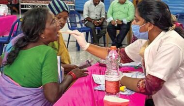 In the village of Uppada, India, Dr. B. Alice Percy, a dentist, looks in a patient’s mouth during a free medical clinic conducted by church members.