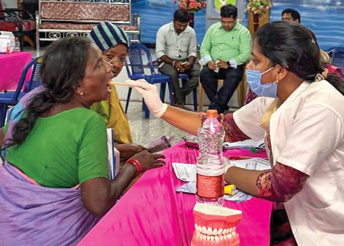 In the village of Uppada, India, Dr. B. Alice Percy, a dentist, looks in a patient’s mouth during a free medical clinic conducted by church members.