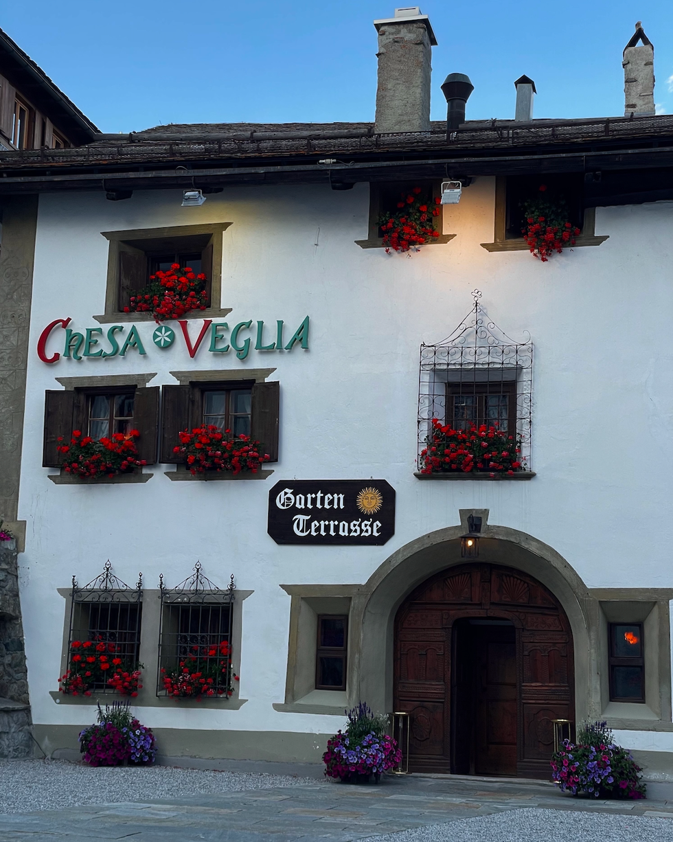 building with a rustic facade prominent signage and flower decorations