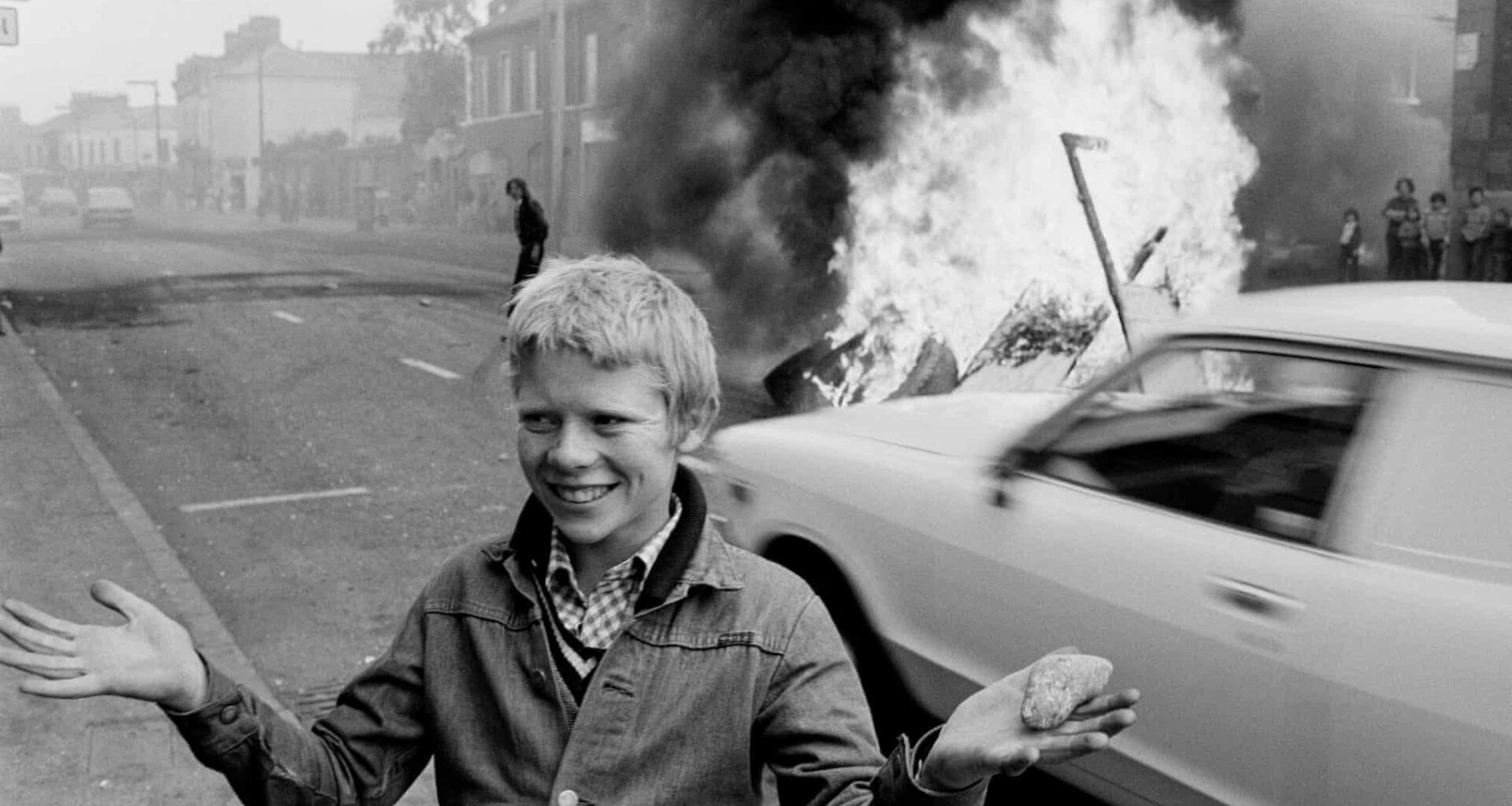 1978: Youth with a stone during a riot at the top of Leeson Street, west Belfast, N Ireland.