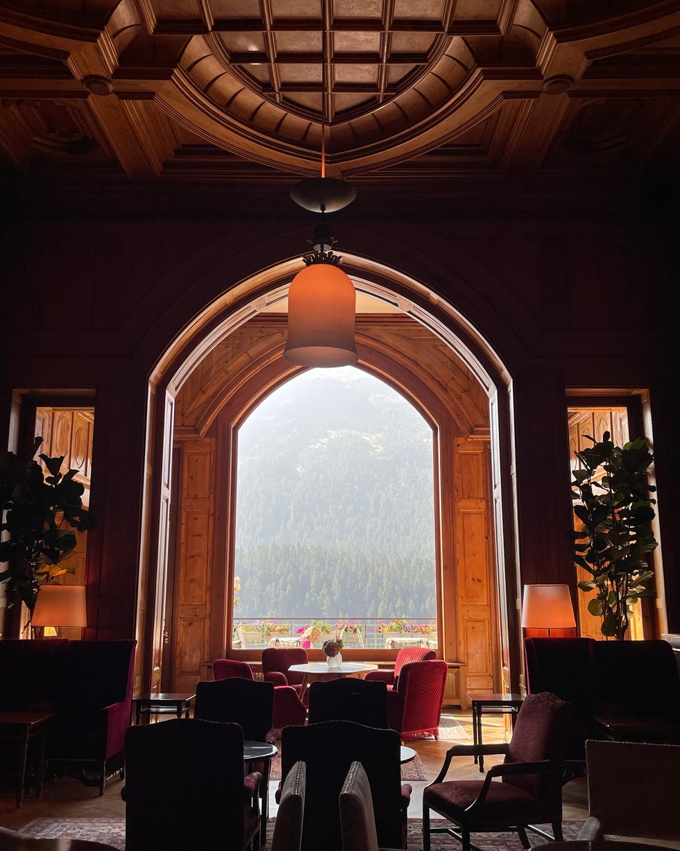 elegant wooden lounge with a view of mountains and trees